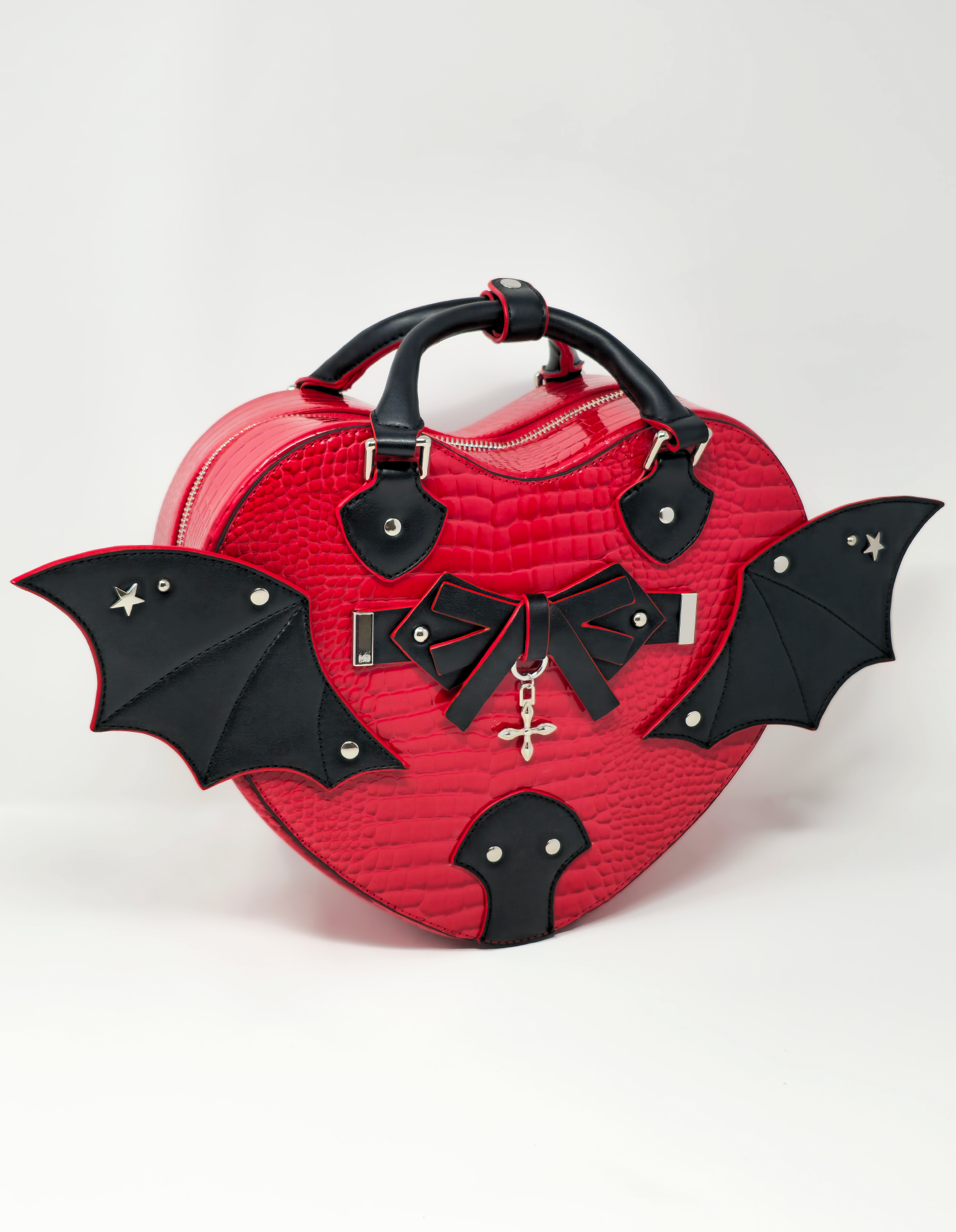 Front view of red faux snakeskin heart bag with black bat wings and gothic bow