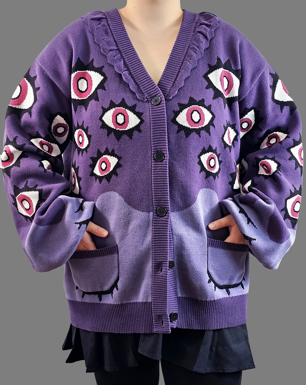 Front-facing view of the Abyss Cardigan in purple, featuring bold pink eye motifs, oversized fit, and two front pockets on 100% cotton knit.