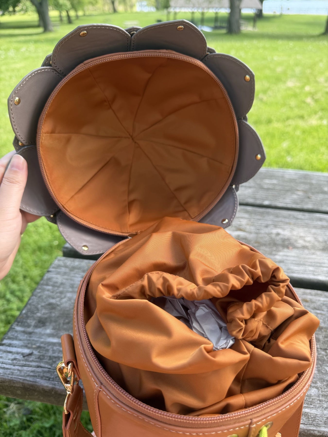 Open acorn-shaped crossbody bag showing the interior lining and inner drawstring pouch for secure storage.