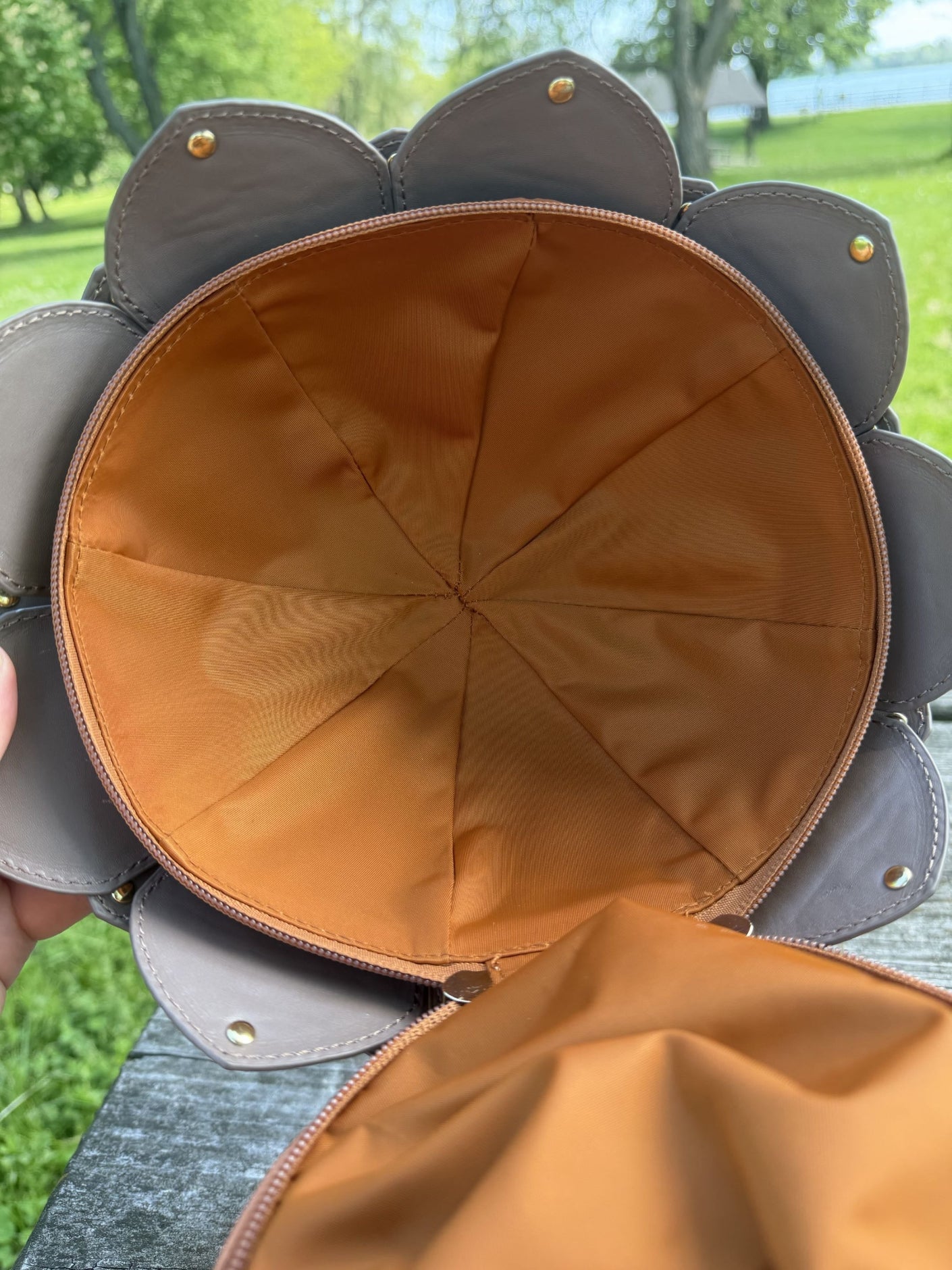 Top-down view of the interior of an acorn-shaped crossbody bag, showing the spacious lined compartment and zippered opening.