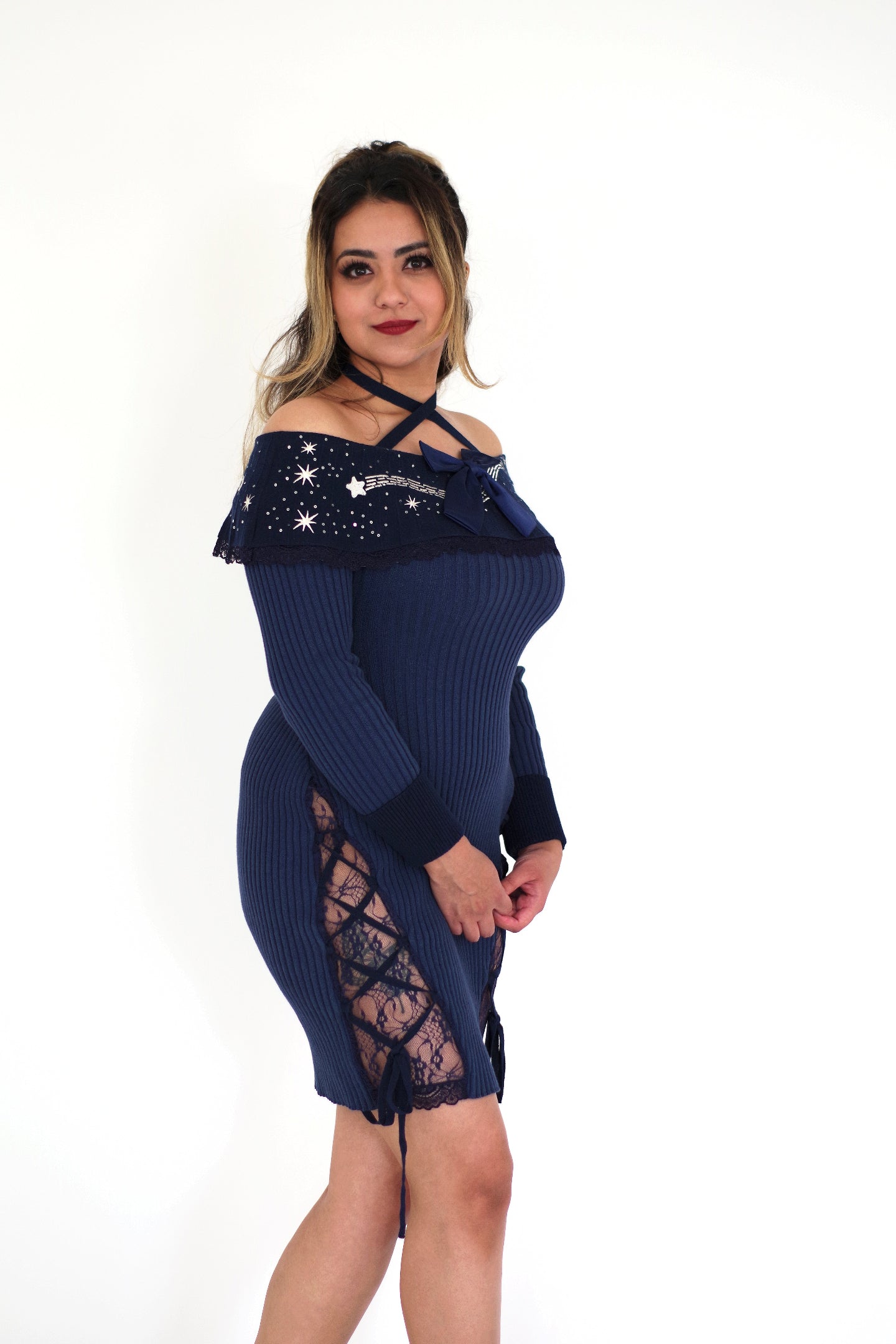 Model wearing a whimsical celestial cotton sweater dress featuring moon and star embroidery, lace-up side panels with lace inserts, and a cozy navy blue knit design.