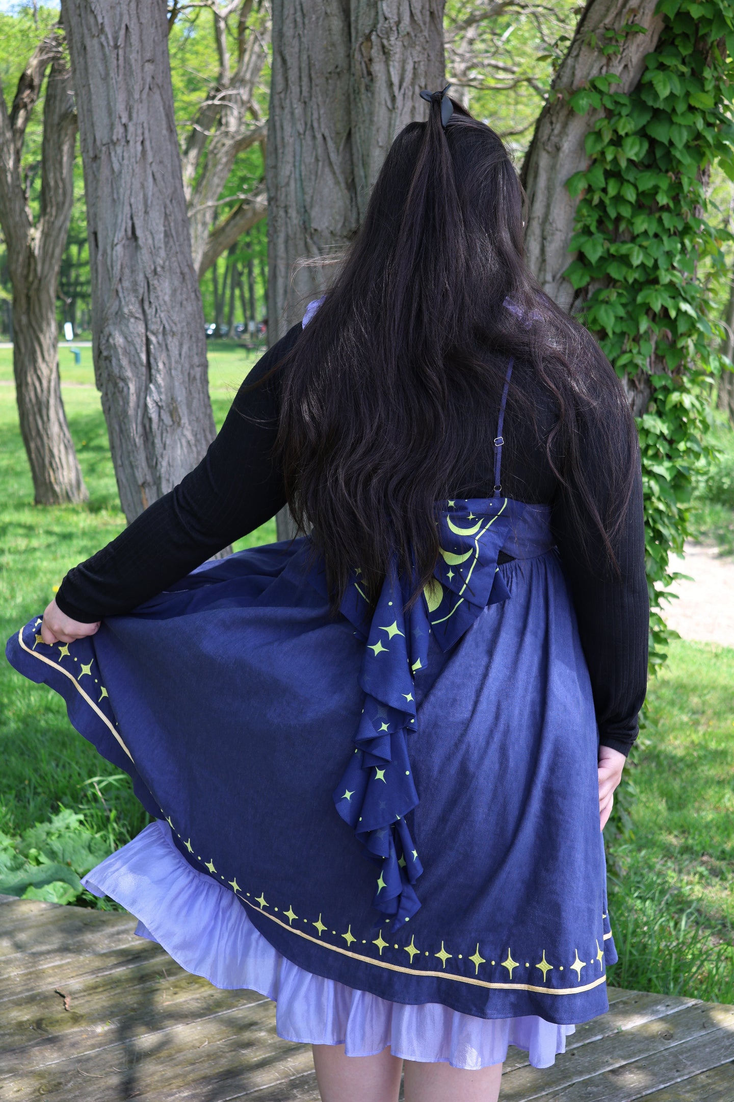 Cosmic moth dress inspired by celestial fashion and whimsical fairycore aesthetics, featuring a decorative moon and stars bow
