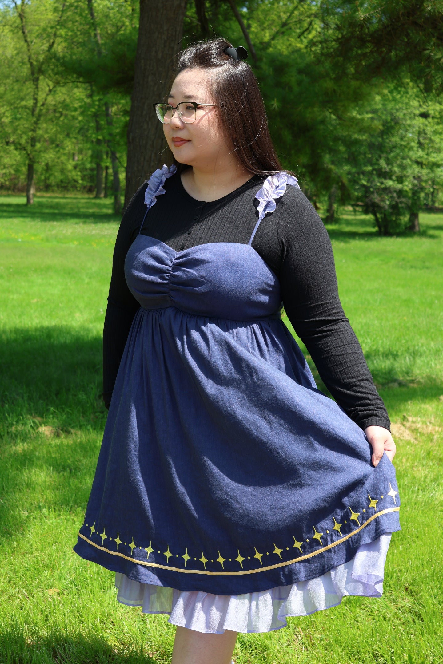 Model wearing the Cosmic Moth Dress with celestial embroidery, ruffled straps, and a flowing fantasy-inspired silhouette