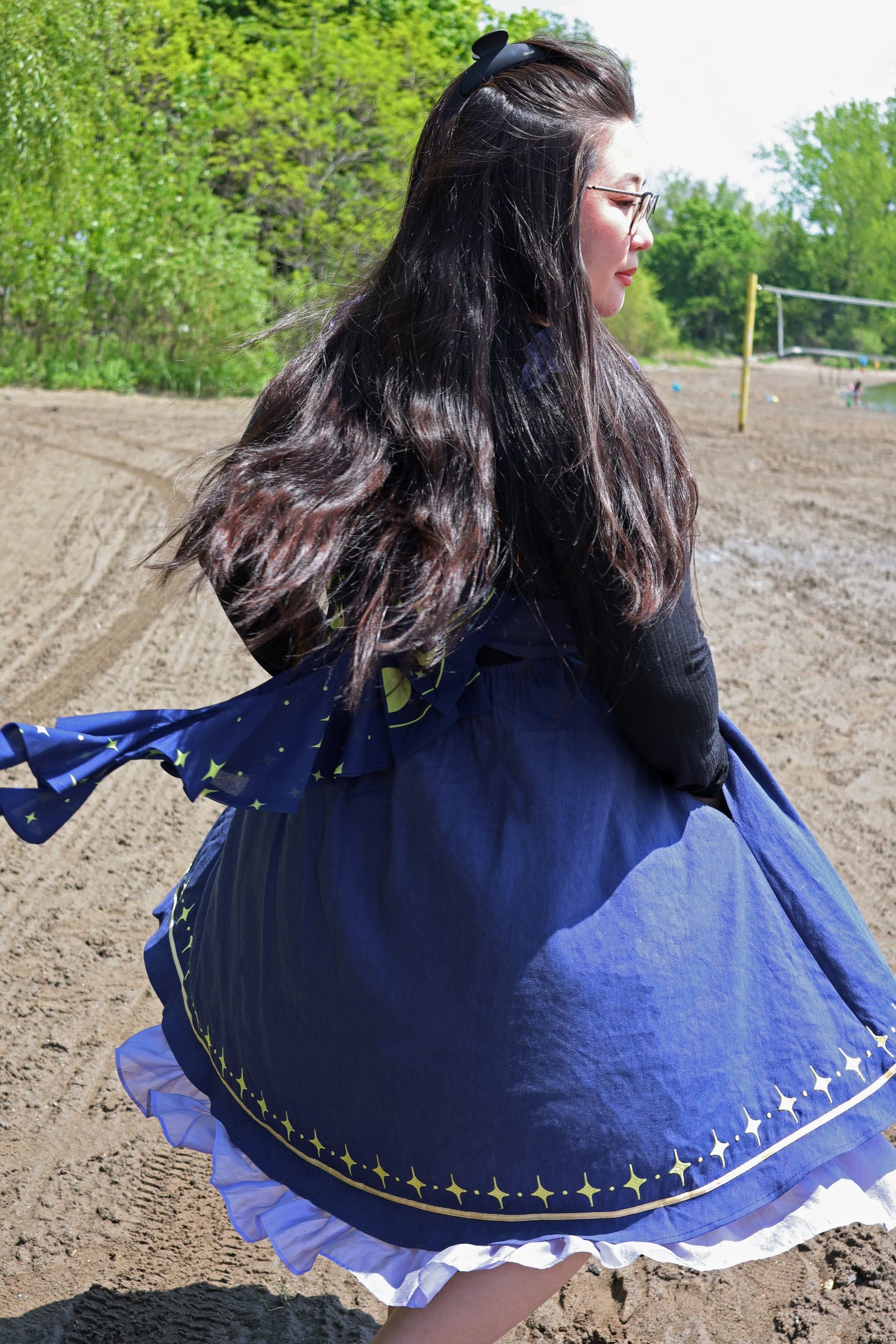 Model twirling in the Cosmic Moth Dress, showcasing the celestial star hem, flowing skirt, and layered fairycore silhouette