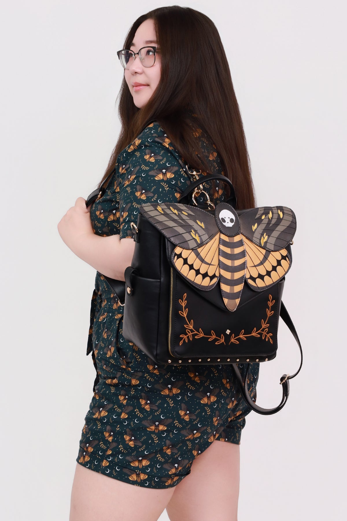 Person wearing a death’s head moth backpack with whimsical fairycore, forestcore, and entomology fashion inspired design