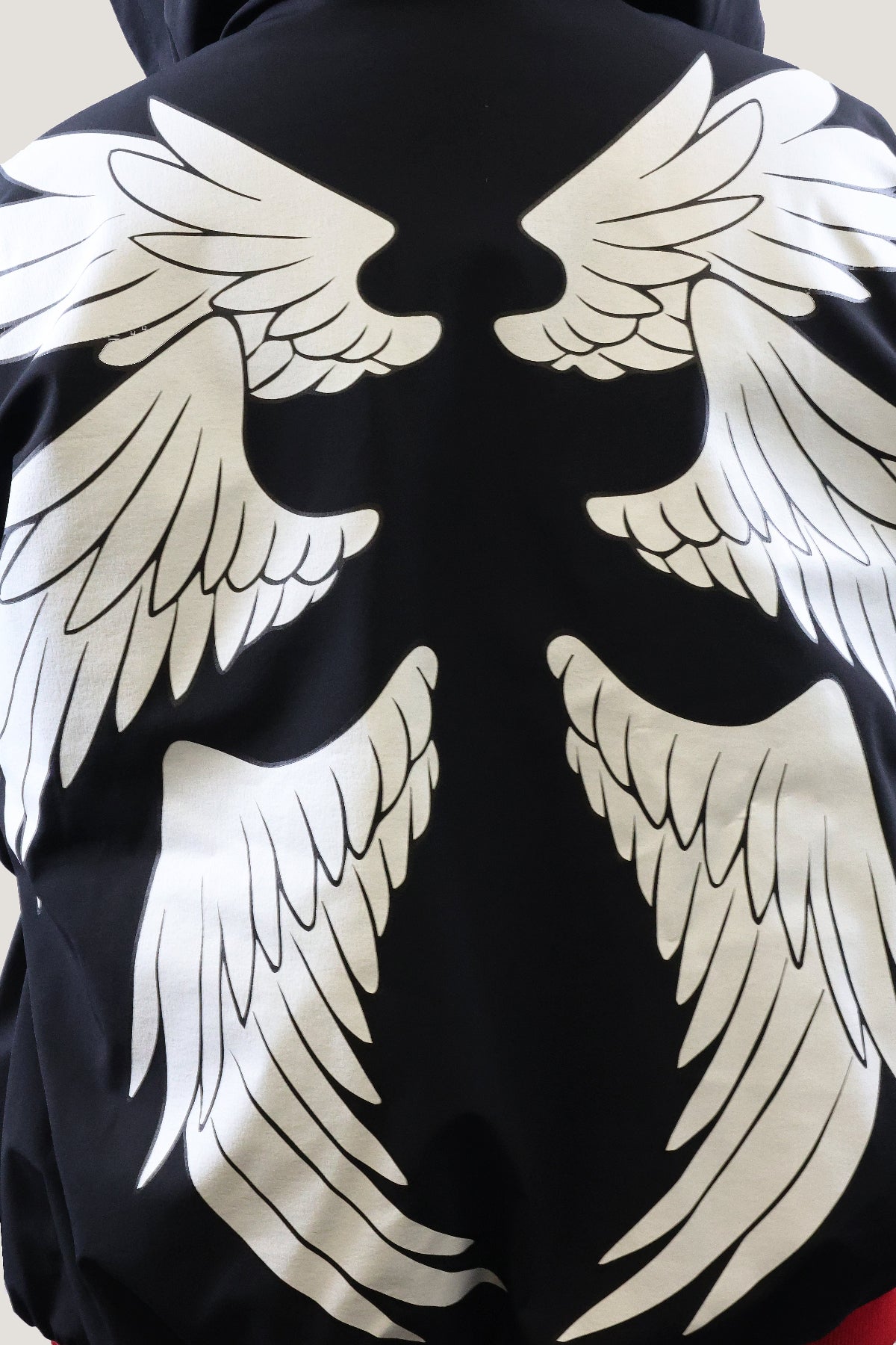Black jacket with large white wings on the back