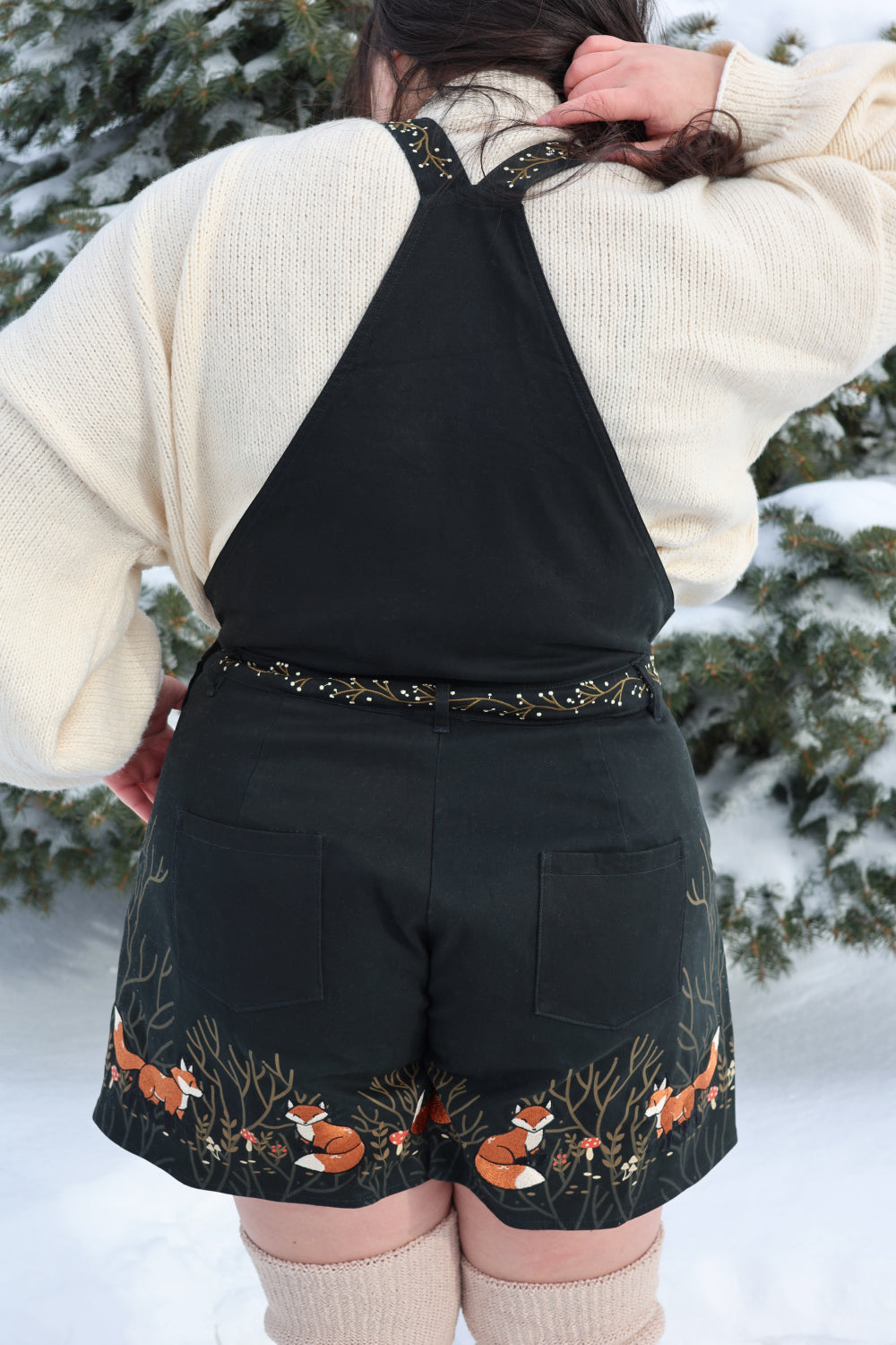 Back view of Forest Tale forestcore overalls with fox embroidery and woodland details.