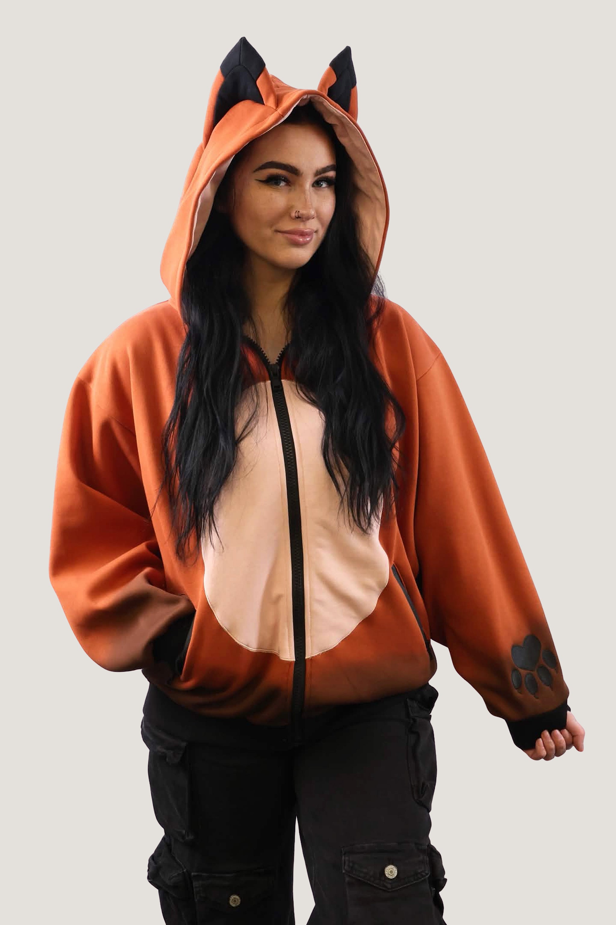 Front view of a model posing in the Fox Hooded Sweatshirt, highlighting the pointed black ears on the hood and the paw print design on the sleeve cuff.