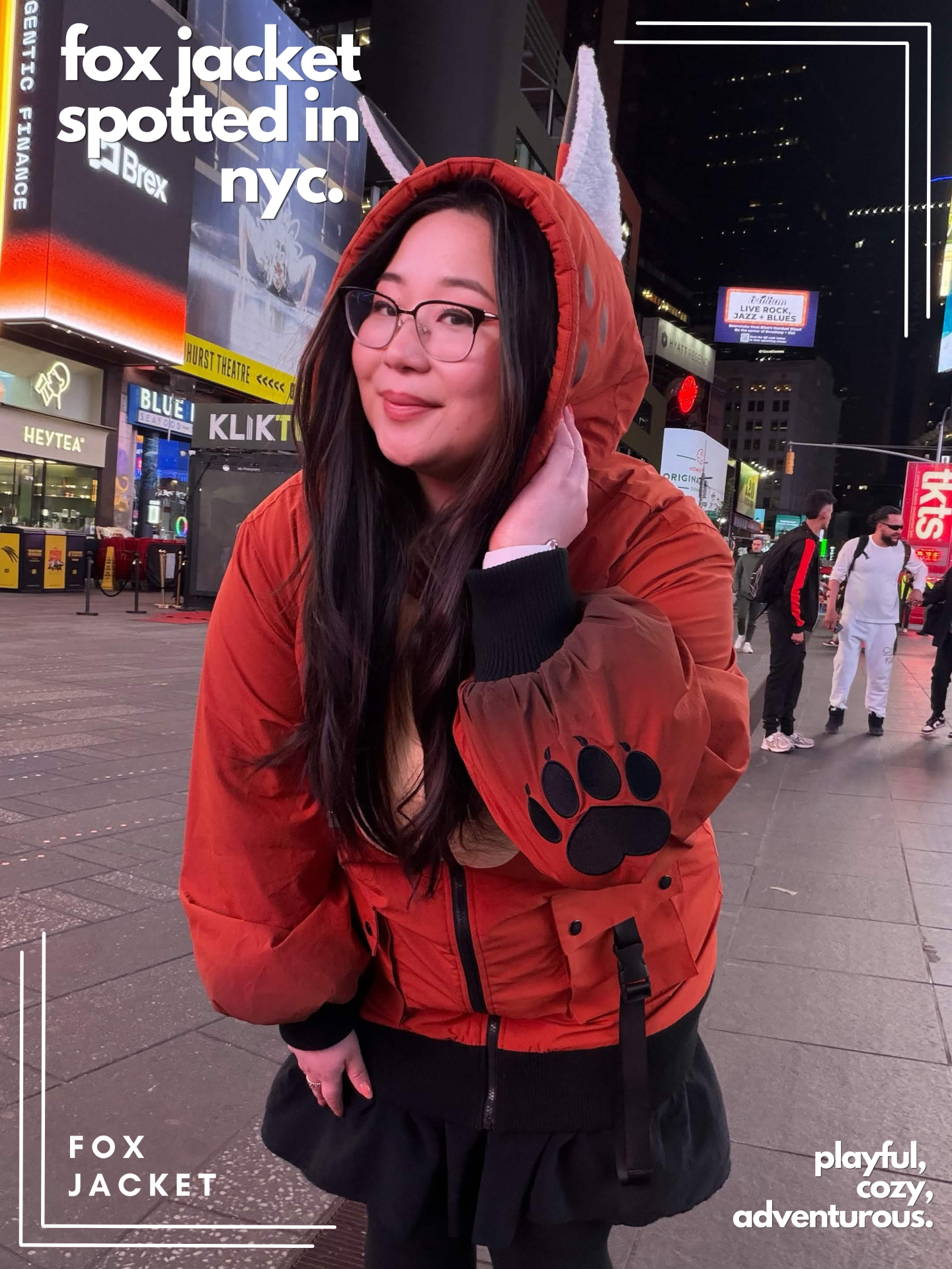 Model wearing the Nyahallo Fox Jacket in Times Square at night, featuring fox ears and paw-print sleeve details.