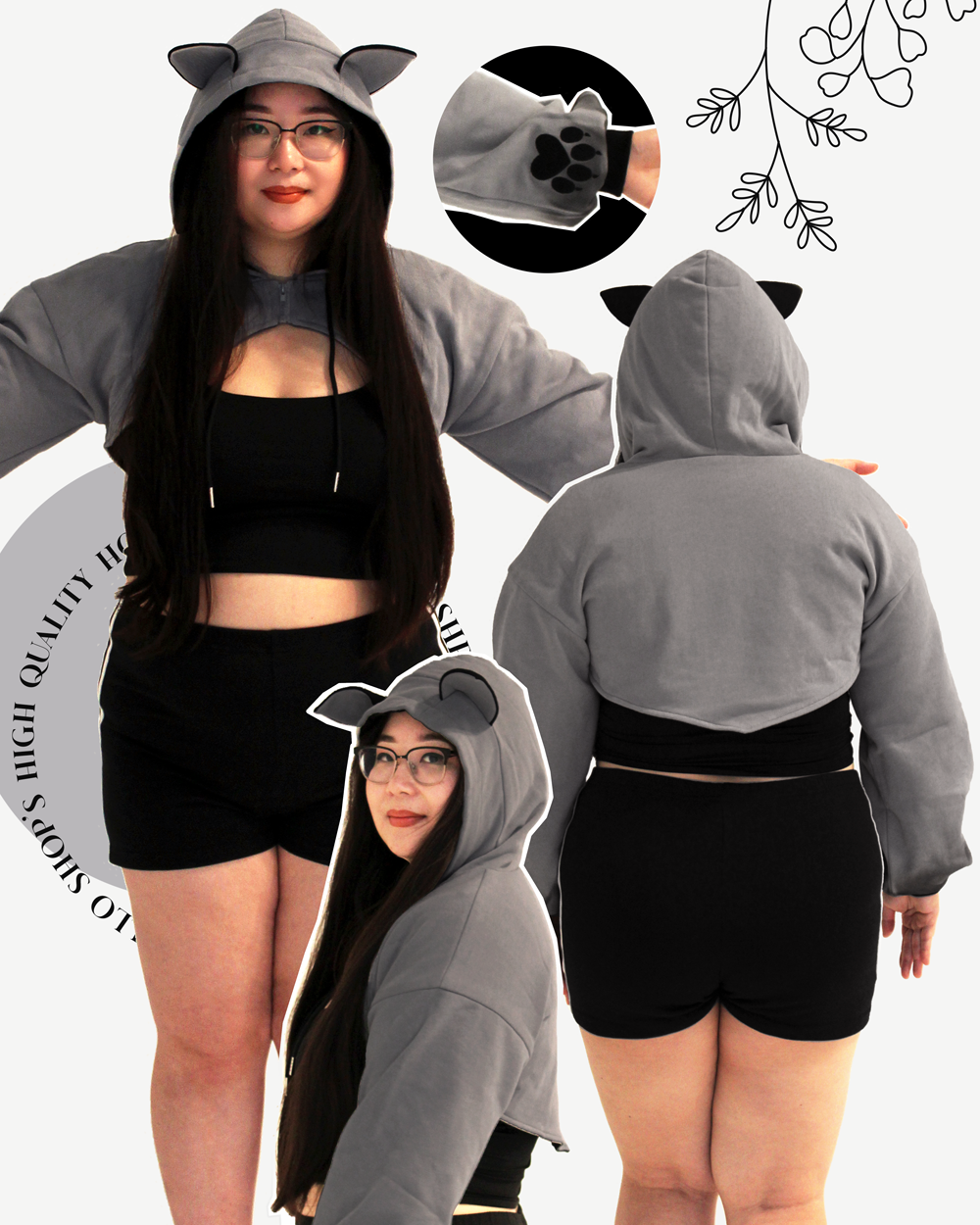 Model wearing a grey wolf themed cropped shrug hoodie with wolf ears, oversized sleeves, and paw print cuff details.