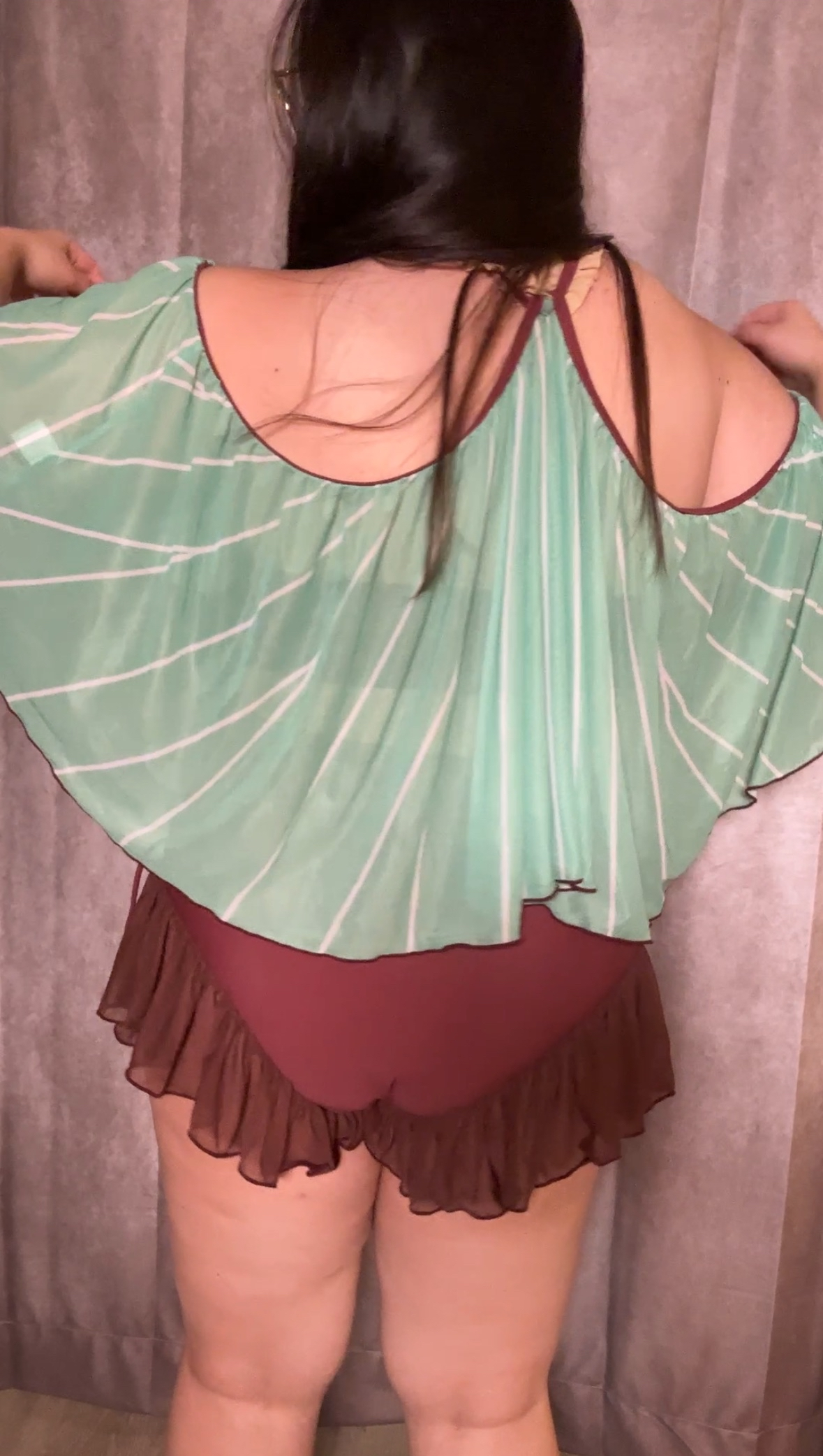 Back view of the Luna Moth Swimsuit prototype featuring a green luna moth wing-inspired cover-up and brown ruffle swim bottoms.
