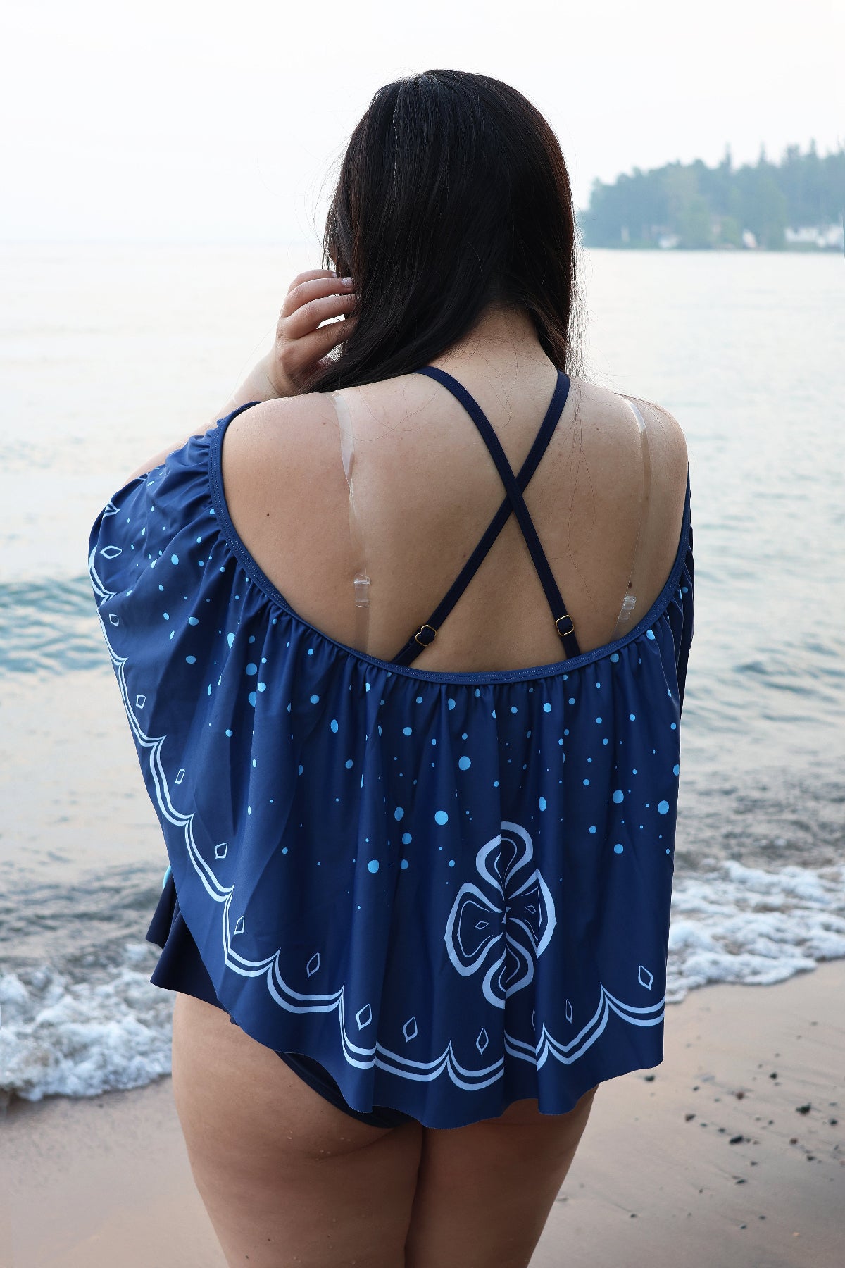 Back view of the Nyahallo Moon Jellyfish Swimsuit with the detachable moon jellyfish-inspired cape, showcasing the crossed shoulder straps and flowing ocean-inspired print.