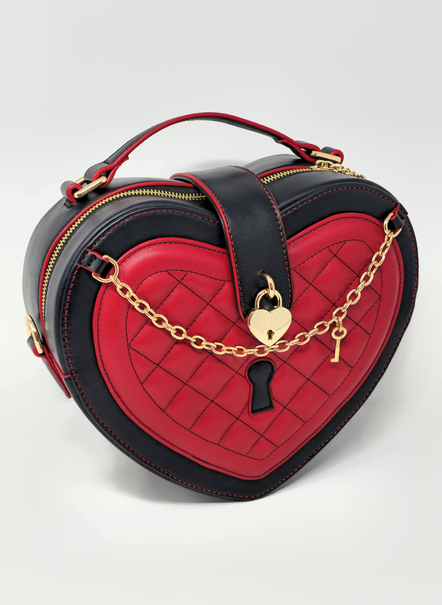 Queen of Hearts heart-shaped handbag featuring quilted red panels, black trim, gold lock and key charms, and romantic gothic-inspired detailing.