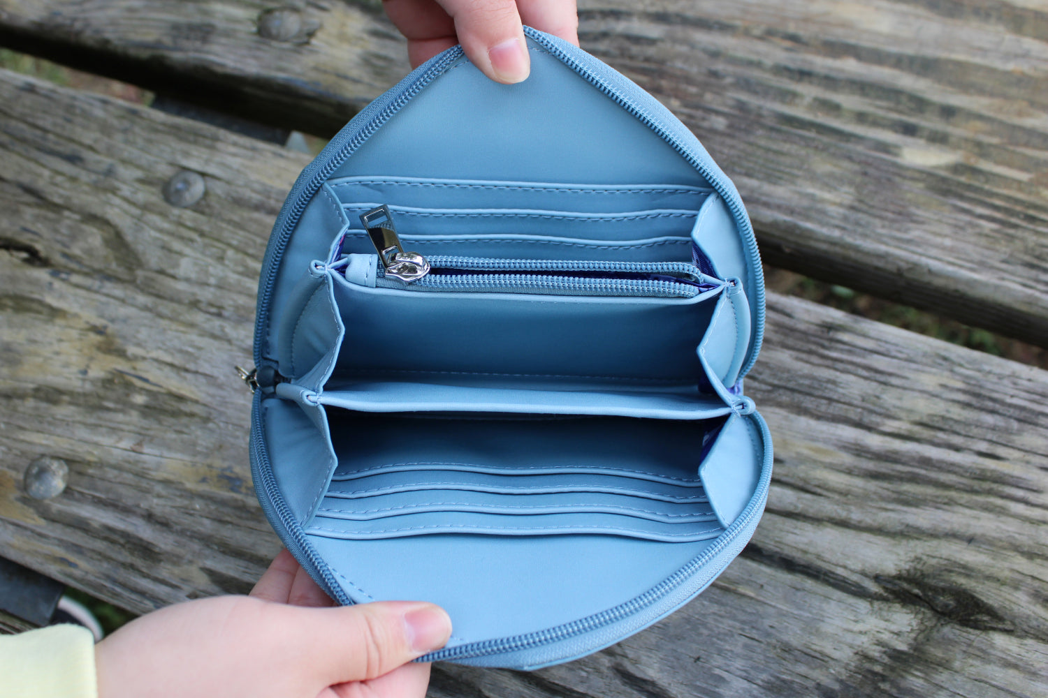 Inside view of a cute shark-shaped vegan leather wallet showing multiple card slots, spacious compartments, and a zippered coin pocket.