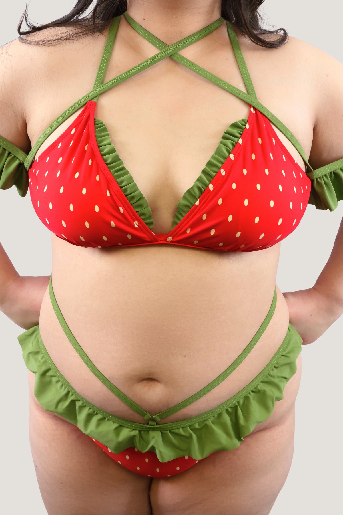 Red and green bikini with strawberry pattern on a plain background