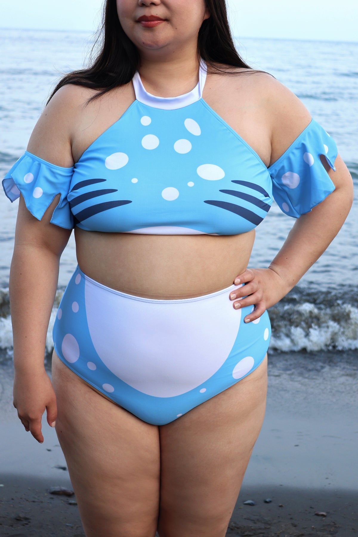 Front view of the blue and white Whale Shark two-piece swimsuit with spotted detailing, fin-inspired sleeves, and high-waisted bottoms.