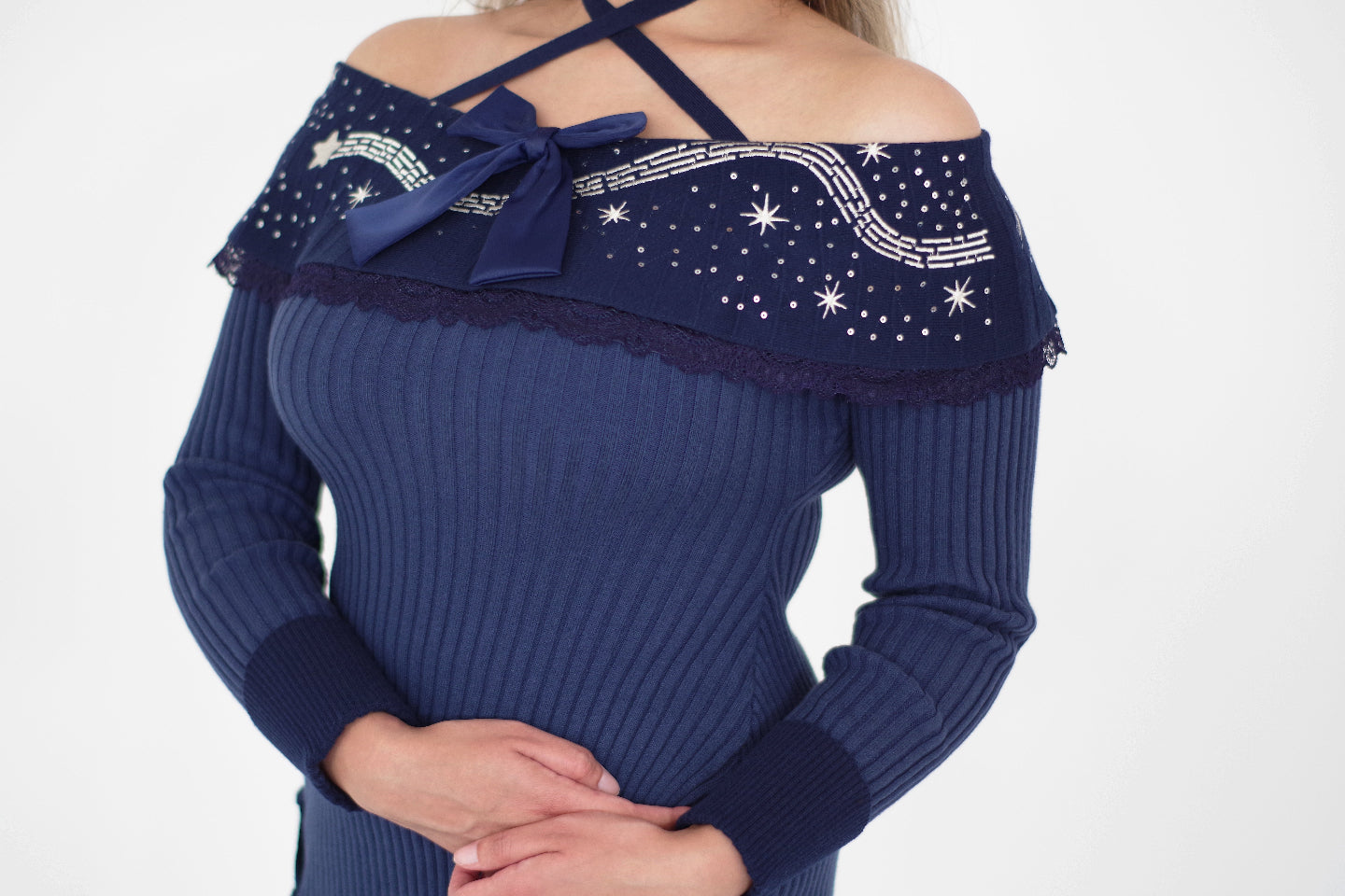 Navy blue celestial sweater dress with star embroidery, lace trim, and ribbon bow detail.