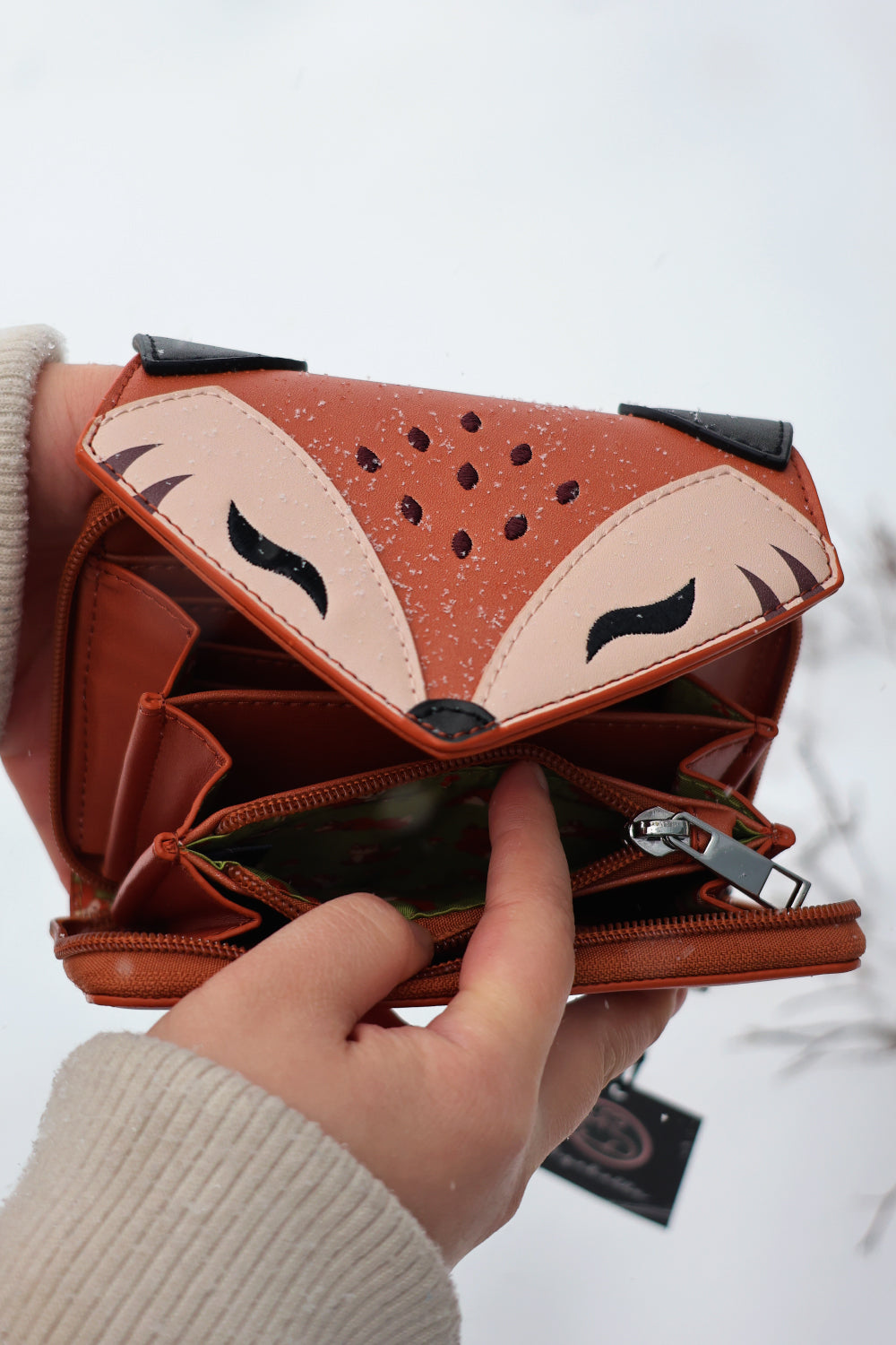 Open woodland fox fantasy wallet showing spacious compartments, zip coin pouch, and vegan leather interior in snowy weather.