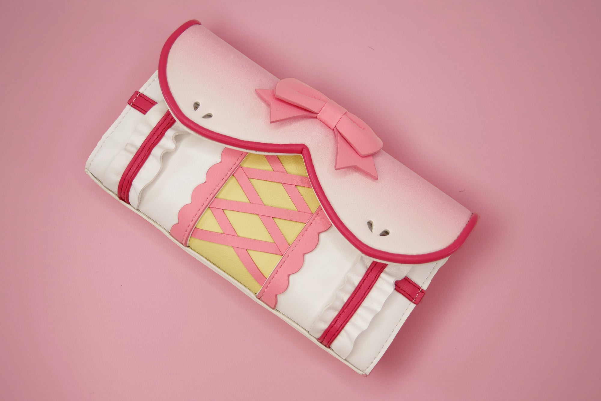 Pink magical girl inspired wallet with bow detail, corset lacing, ruffles, and kawaii anime fashion styling.