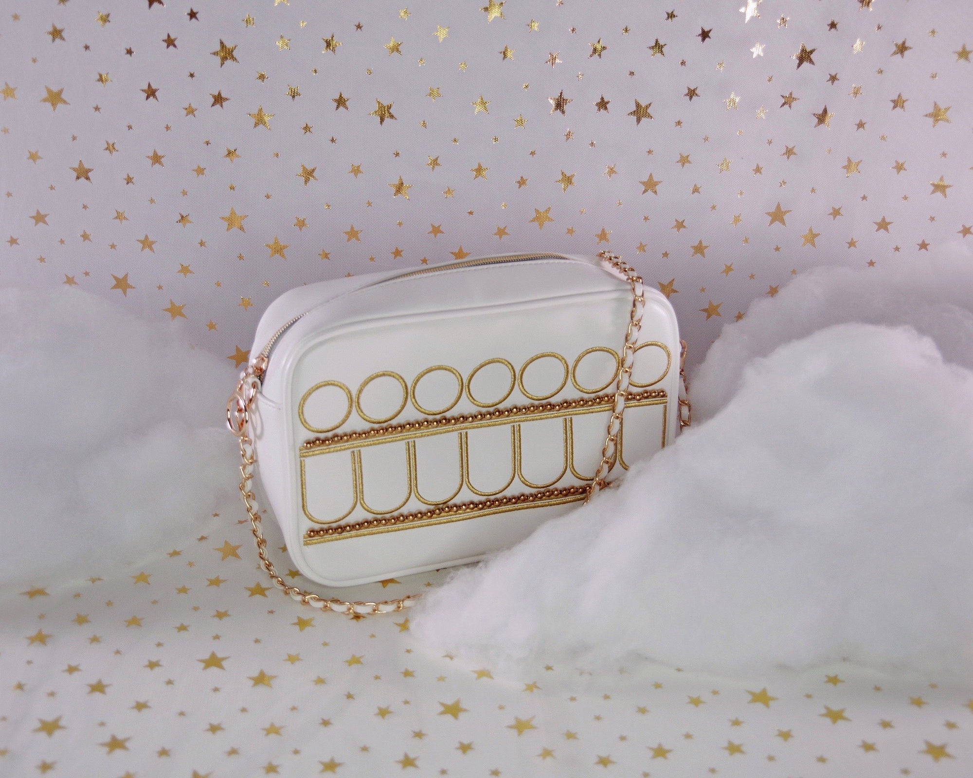 Celestial princess handbag with gold embroidery, white faux leather, gold chain strap, and magical starry aesthetic.